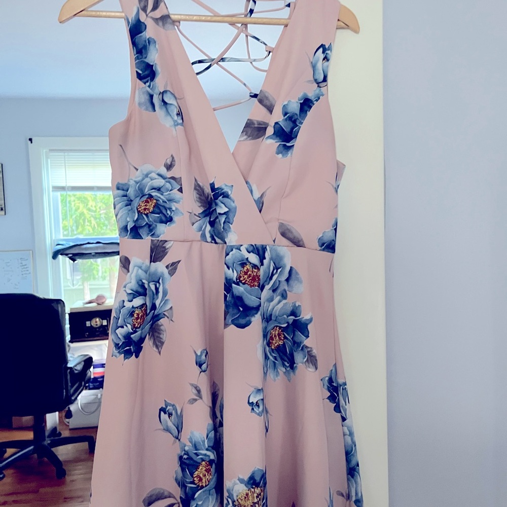 Mini dress from lulus. Pink with light blue flowers. Open cross back design.